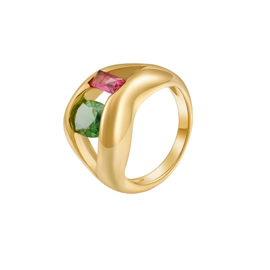A gold ring with a twisted, open band design featuring two rectangular gemstones, one pink and one green, set against a plain white background.