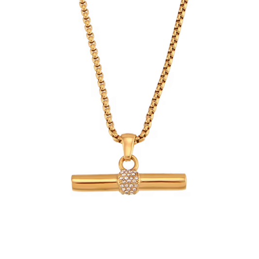 A gold-toned necklace featuring a horizontal bar pendant with a small, clear crystal-detailed ball accent in the center, suspended from a matching box chain against a plain white background.